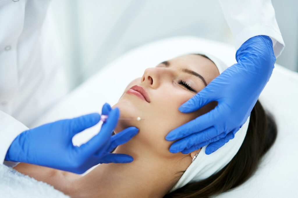 Beautiful young woman getting polydioxanone thread lifting at beauty salon.