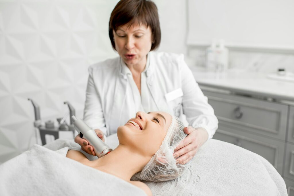 Senior woman cosmetologist during the procedure