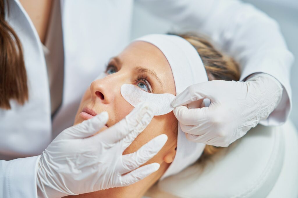 Woman having cosmetology eyebrows treatment in beauty salon