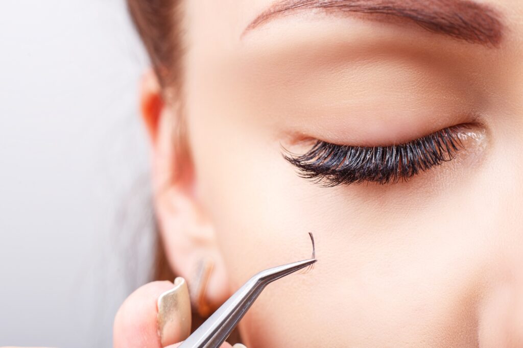 Eyelash Extension Procedure. Woman Eye with Long Eyelashes. Lashes, close up, macro, selective focus