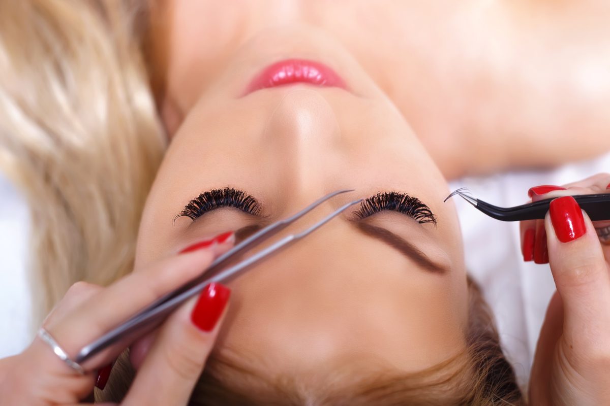 Eyelash Extension Procedure. Woman Eye with Long Eyelashes. Lashes, close up, selected focus