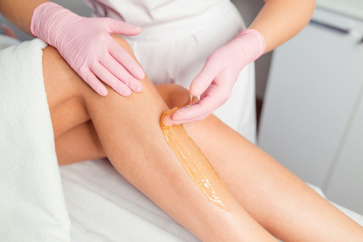 Professional waxing depilation procedure with sugar paste